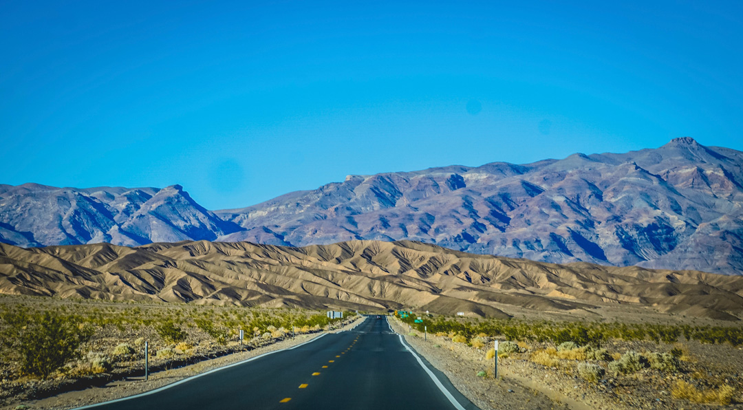 stretch of road leading to death valley with views of the hills