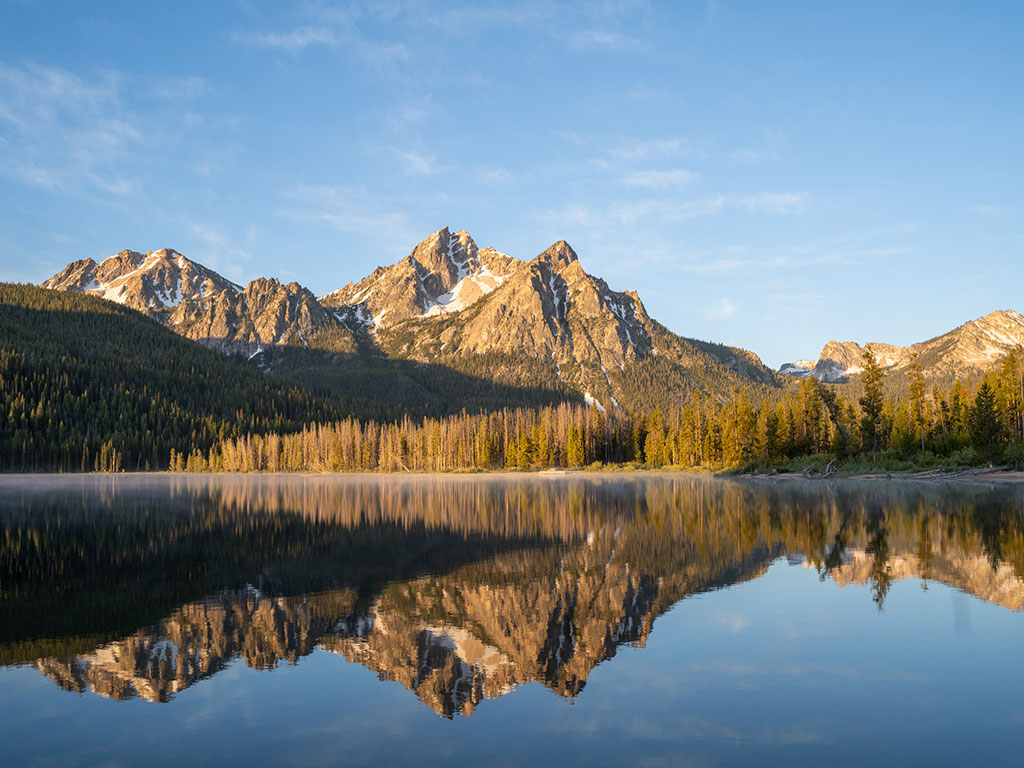 sawtooth mountains reflected on stanley lake in idaho