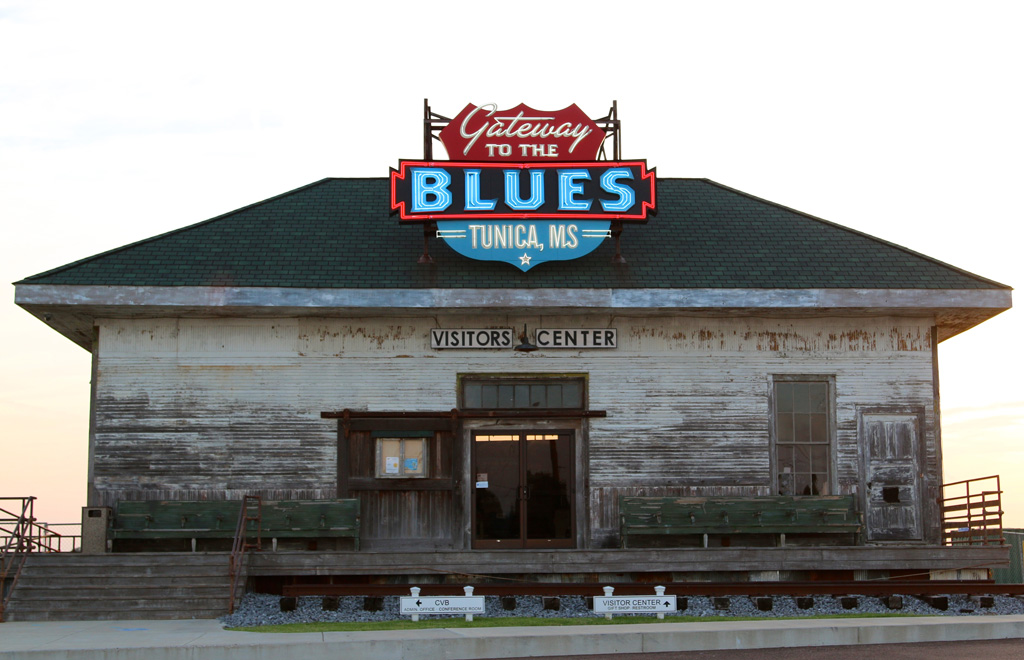 front view of an old building with neon sign that says Gateway to the Blues