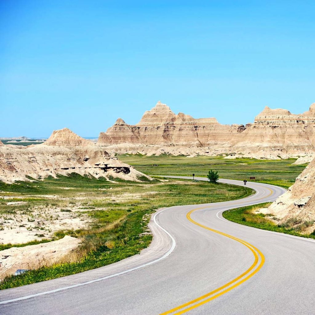 August road trips: Winding road through South Dakota's Badlands National Park is perfect.