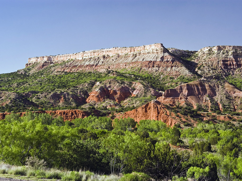 rocky cliffs and green brush in Palo Duro Canyon