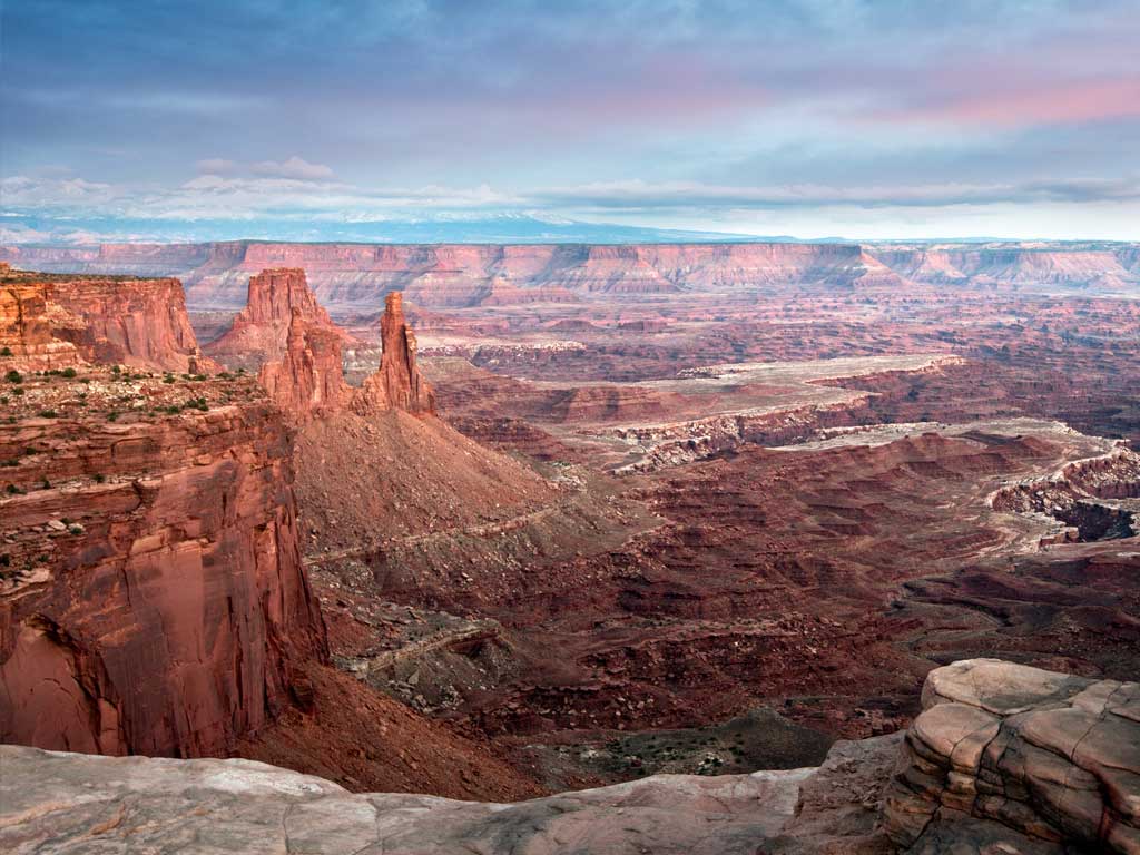 blue and pink sky over a deep canyon